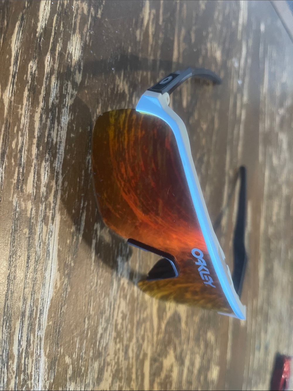 Oakley White Frame Sunglasses with Orange-Red Mirrored Lens